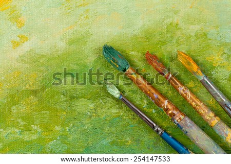 Artists vintage tools brushes on green artistic background