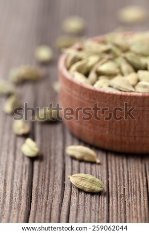 Green cardamom super food ayurveda asian aroma spice in a wooden bowl on vintage background