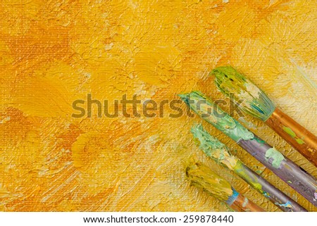 Artists vintage tools brushes on yellow artistic background