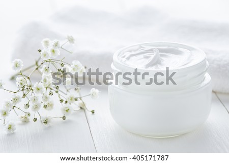 Yogurt cream beauty cosmetic product wellness and relaxation makeup mask in glass jar with towel on white background