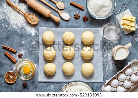 Buns dough homemade preparing recipe, ingridients food flat lay on kitchen table background. Working with butter, milk, yeast, flour, eggs, sugar pastry or bakery cooking.
