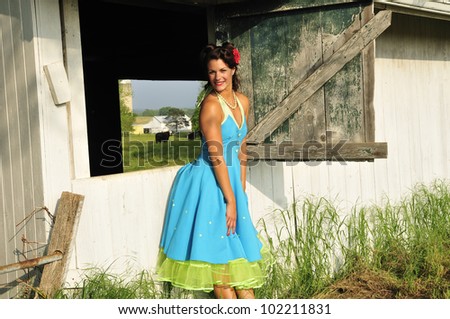 beautiful lady dressed in vintage attire standing in a country farm