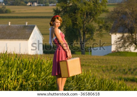 young woman dressed up in vintage attire waiting for a ride in the Pennsylvania country side