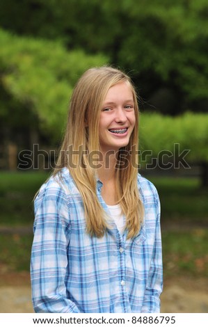 pretty teenage girl with braces smiling
