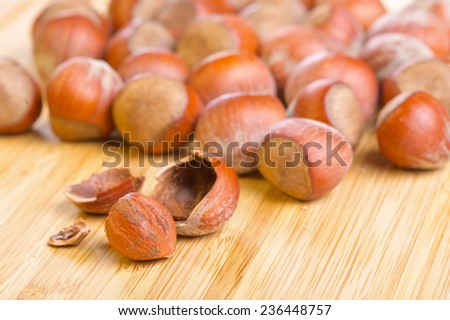 Hazelnut or filbert kernel and its shell on old wooden background
