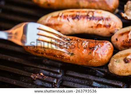 Beef and pork sausages on grill or barbecue