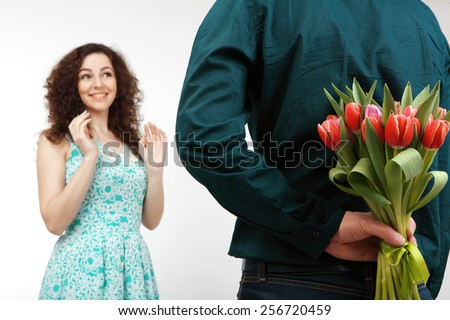Man gives a girl a bouquet of pink tulips