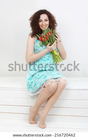 Girl with a bouquet of pink tulips on a white background