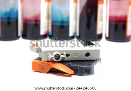 inkjet printer cartridges in bottles with background colors