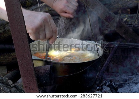 soup cooking in a pot on the fire