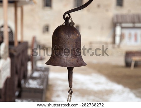 An old metal bell with the rope