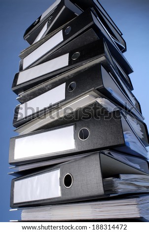 A stack of file folders on a blue background.