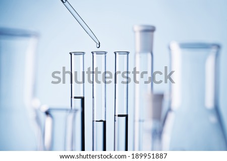 Laboratory scene with pipette and test tubes.