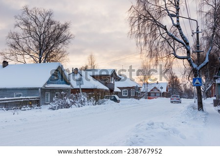 Winter landscape in the northern Russian city in evening twilight at sunset time. Kargopol city, one of the streets