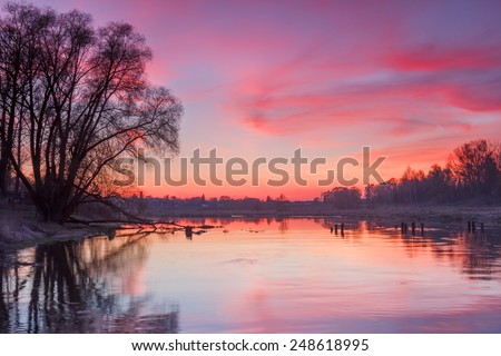 Spring landscape on the river with bright sunset. Moscow river near Mozhaisk, Moscow region, Russia