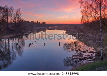 Spring landscape on the river with bright sunset. Moscow river near Mozhaisk, Moscow region, Russia