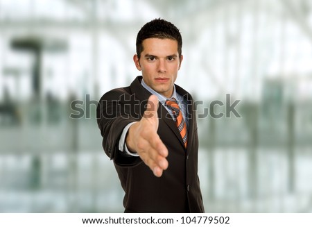 young man in suit offering to shake the hand