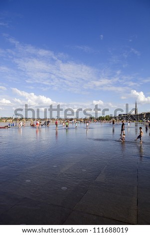 BORDEAUX, FRANCE - AUGUST 8: Bordeaux water mirror full of people in one of the hotest summer days, having fun in the water, on August 8, 2012 in Bordeaux, France.