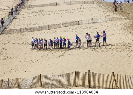 PYLA SUR MER, FRANCE - AUGUST 8: People from Siblu organization in action against cancer in the famous dune of Pyla, on August 8, 2012 in Pyla Sur Mer, France.