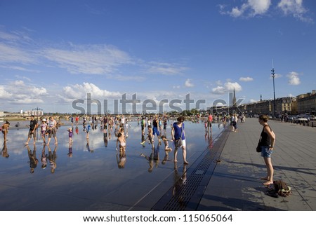 BORDEAUX, FRANCE - AUGUST 8: Bordeaux water mirror full of people in one of the hotest summer days, having fun in the water, on August 8, 2012 in Bordeaux, France.