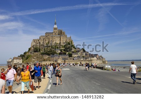 Mont Saint Michel, Brittany, France - August 11: People Visiting The Mont Saint Michel, In The North Of France, August 11, 2012 In Mont Saint Michel, Brittany, France