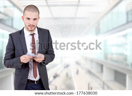 young businessman with money at the office