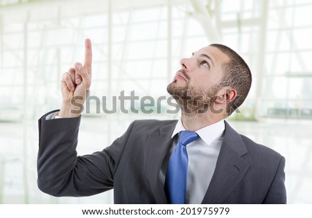 businessman in a suit pointing with his finger at the office