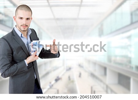young casual man with lots of money at the office