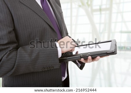 businessman using touch pad, close up shot on tablet pc at the office