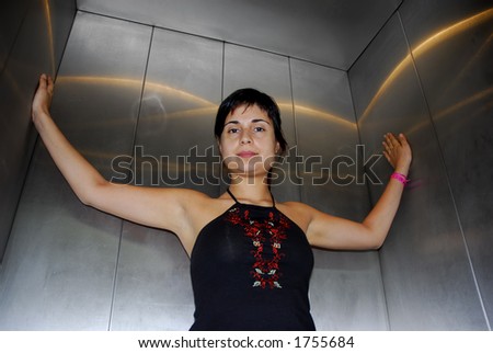 girl inside an elevator looking sexy