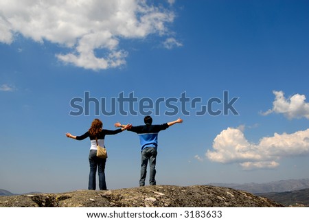 young couple in the top of the mountain