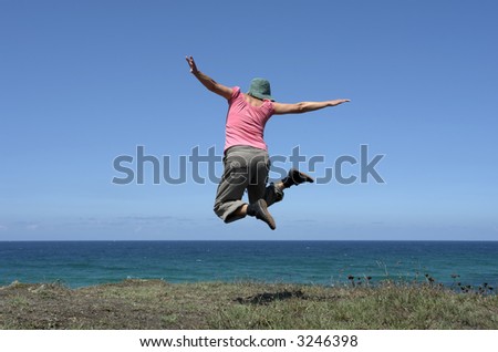happy woman with a big jump at the coast