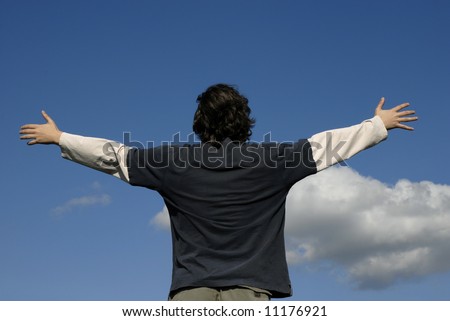 man with open arms and the blue sky
