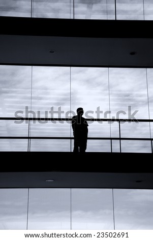 young man in silhouette in a modern office building