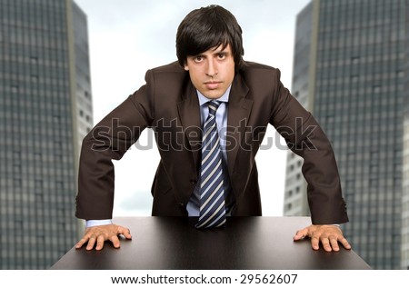 young worried business man, on a desk