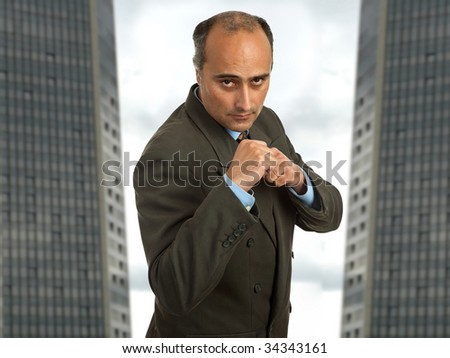 mature business man portrait with two buildings on the back