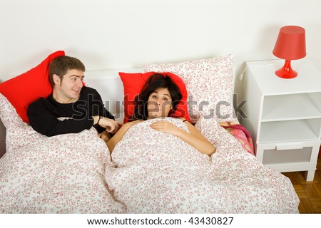 young couple in bed, studio picture