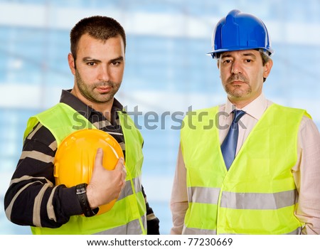 proud boss and worker standing looking at the camera