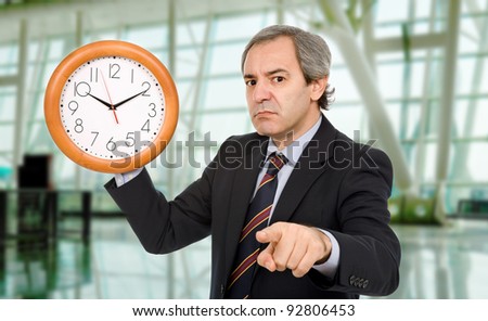 mature mad business man with a clock
