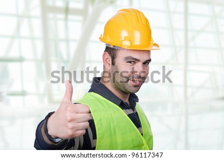 Worker wearing hard hat and going thumb up