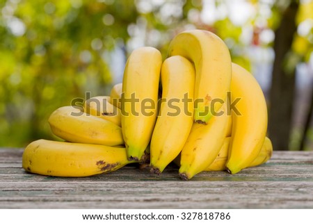 organic bananas on the wooden table at the farm, outdoor