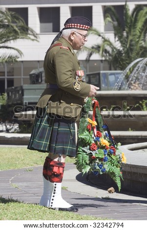 CAPE TOWN, - NOVEMBER 9: A Warrant Officer of the Pipe Band of the Cape Field Artillery, South African Defence Force, lays a wreath to commemorate Armistice Day in Cape Town, South Africa on November 9, 2008