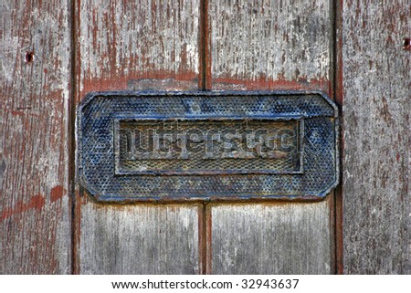 Vintage letter box in a wooden door