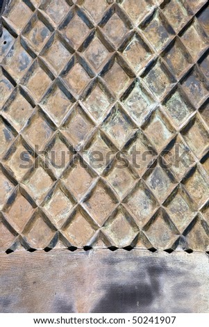 Abstract geometric pattern in iron cladding of structure in Cape Town harbour, South Africa
