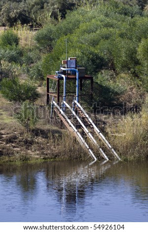 Electric water pumps pump water from the Breede River in the Western Cape Province of South Africa to irrigate arid farmland adjacent to the river.