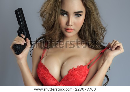 Sexy asian female model holding guns