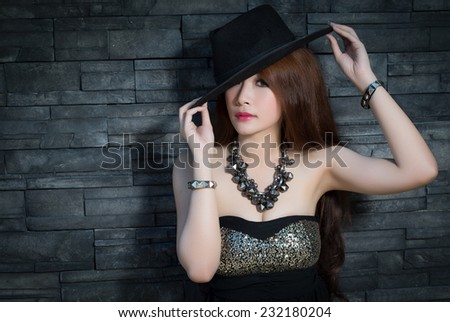 Young beautiful Asian model wearing black dress