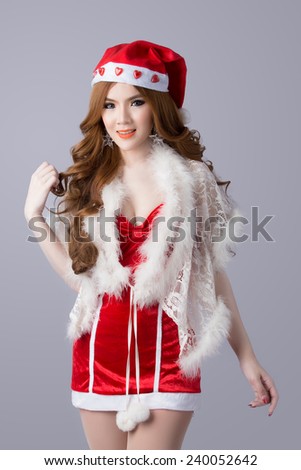 Beautiful asia woman model in Santa Claus clothes - in studio