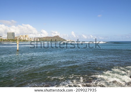 Description:  Summer in Honolulu with surfers enjoying waves at Ala Moana Surf Spot. Title:  Summer in Hawaii.