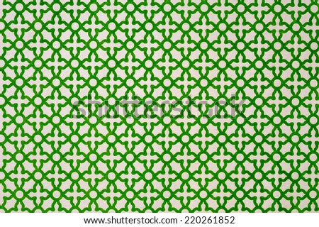 Description:  Emerald green geometric cloth on champagne  background. Title:  Emerald green background.